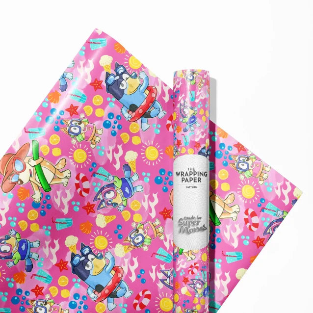 Child excitedly unwrapping a present wrapped in colorful Bluey paper.