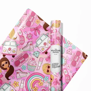 "Child smiling while unwrapping a present covered in festive Barbie wrapping paper."