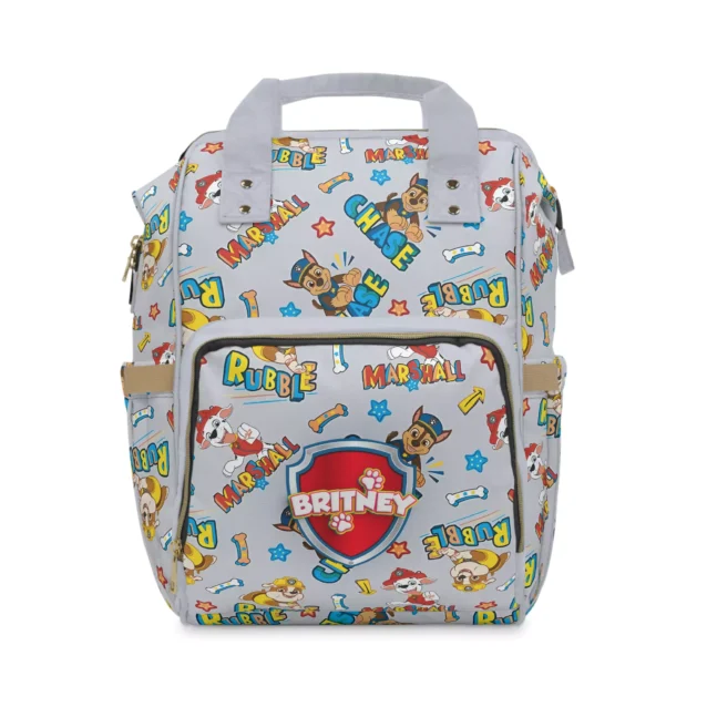 Grey Paw Patrol diaper bag backpack with the pups and comic-style "Game" and "Battle" lettering.