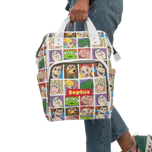 Happy mom wearing the personalized Toy Story maternity backpack comfortably while walking her baby in a stroller.