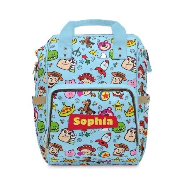 Light blue Toy Story diaper bag backpack with tossed Woody, Jessie, Lotso and alien cartoon icons.