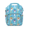 Bright blue Baby Shark diaper bag with party-hat sharks, coral and seaweed, personalized with the baby's name.