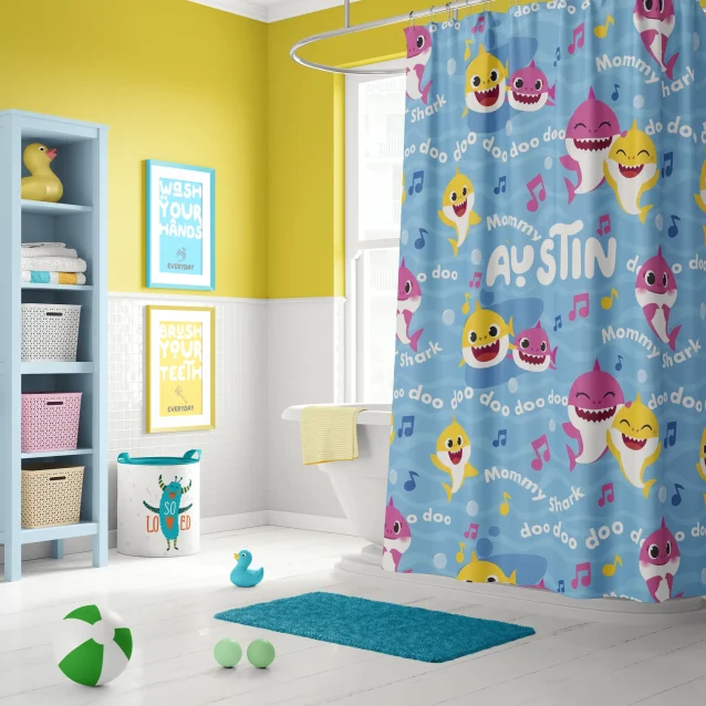 Custom Baby Shark shower curtain with personalized child's name in a bright kids bathroom.