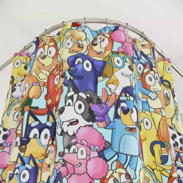 Bluey and Bingo playing in the bath on a fabric shower curtain.