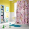 Barbie shower curtain with pink logo in a stylish, modern bathroom.