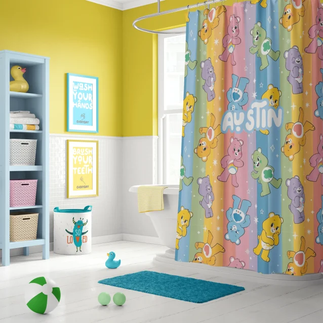 A child smiling at their personalized Care Bears shower curtain with their name on it.