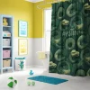Slytherin shower curtain creating a magical atmosphere in a green and silver themed bathroom.