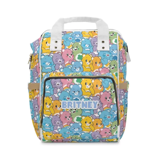Colorful Care Bears diaper bag backpack with the Care-a-Lot cast collage of bears on blue, the baby's name printed on the front pocket.