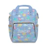 Periwinkle Care Bears diaper bag backpack with Share Bear and friends among clouds and rainbows.
