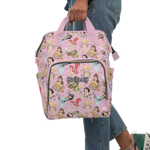 A happy parent using the organized and stylish Disney Princess Diaper Bag.