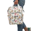 A dad comfortably wearing the Disney Princess diaper bag with a smiling baby in a carrier.