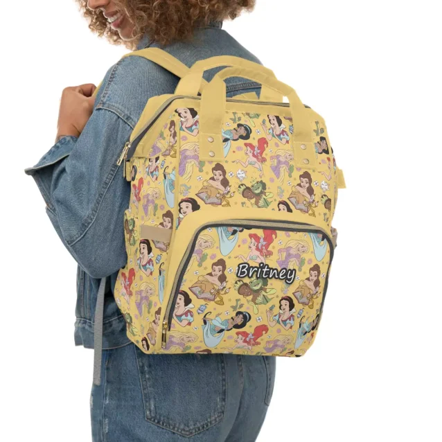 A mother carrying the Disney Princess Diaper Bag on her back, showcasing its comfortable fit.