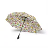 The Hello Kitty umbrella folded to its compact size next to a handbag for scale.