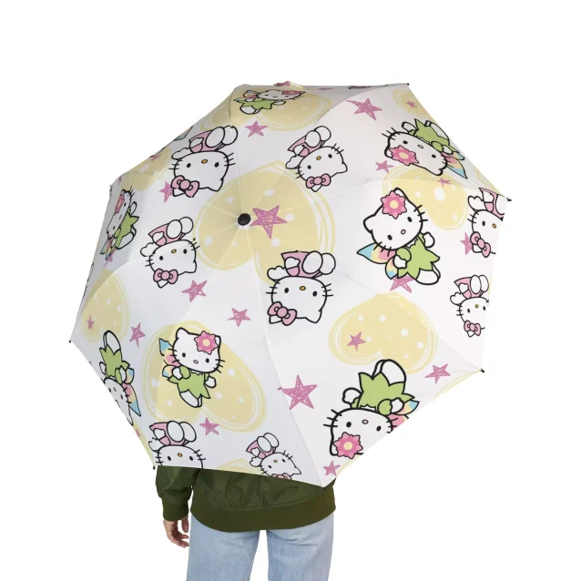 A lifestyle image of someone walking down the street with the Hello Kitty umbrella.
