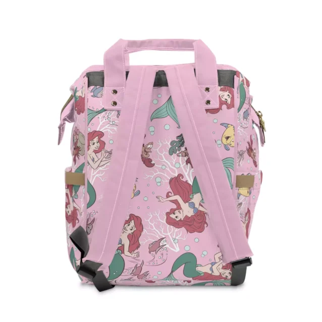A happy parent using the organized Little Mermaid diaper bag.
