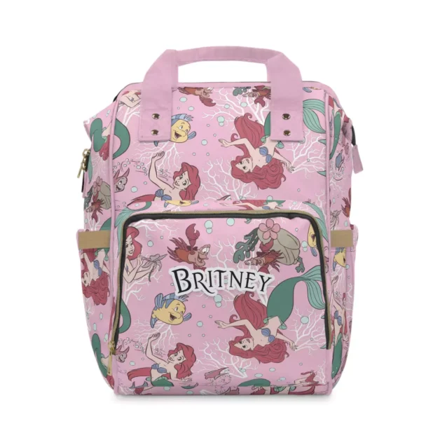 Pink Little Mermaid diaper bag backpack with Ariel and Flounder artwork, personalized with the baby's name.