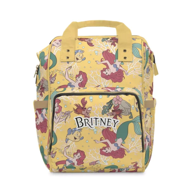 Yellow Little Mermaid diaper bag backpack with Ariel, Flounder and sea flowers.