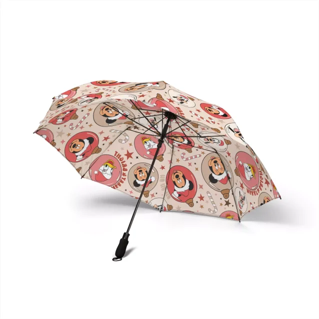 A person using the Mickey Christmas Mouse Umbrella in the rain, with water beading on the waterproof fabric.