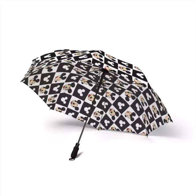Rain beading on the waterproof canopy of the Mickey Mouse umbrella.