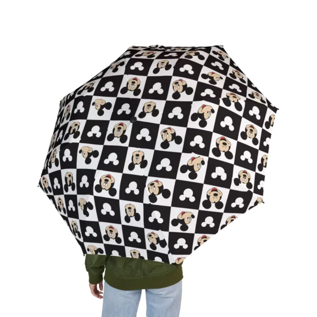The Mickey Mouse umbrella standing open to dry after a downpour.