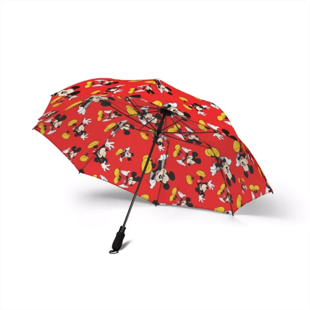 The Mickey Mouse umbrella tucked under an arm, folded away.