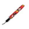 The Mickey Mouse umbrella held against a grey, rainy sky.