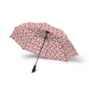 A child carrying the Mickey Mouse umbrella on the way to school.