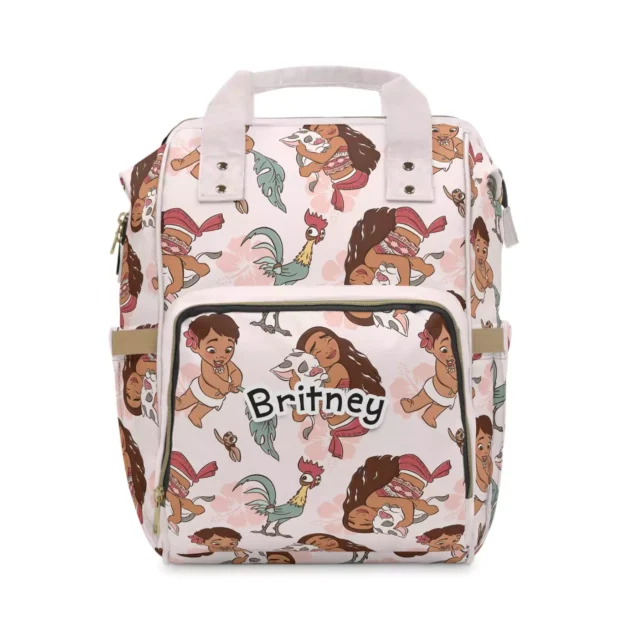 Soft pink Moana diaper bag backpack with baby Moana and Hei Hei the rooster doodles, the baby's name printed on the front pocket.