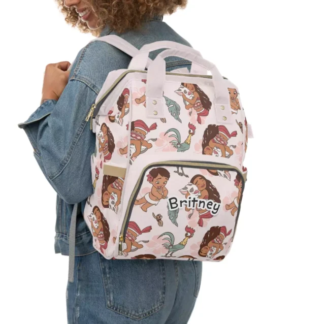 Moana diaper bag worn as a backpack, baby Moana and Hei Hei print.