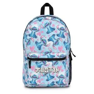 A personalized blue Stitch backpack for kids, featuring a tropical leaf pattern and a custom name for school.