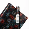Personalized Stranger Things wrapping paper roll and a beautifully wrapped birthday gift featuring the iconic glowing red retro neon title text on a black background.