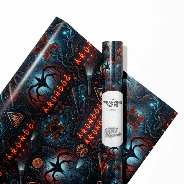 Stranger Things Christmas wrapping paper variant showing the classic hand-painted wall alphabet and tangled colorful holiday string lights design for geeky holiday gift wrapping.