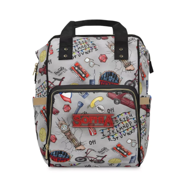 Open main compartment of nylon Stranger Things backpack filled with diapers and blankets.