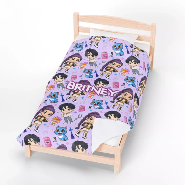 Kpop Demon Hunters merchandise showing the HUNTR/X logo on a black fleece throw.