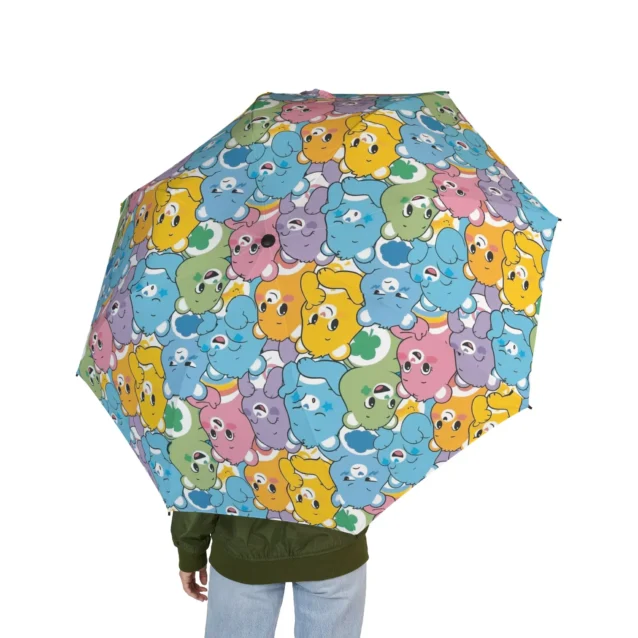 Ergonomic soft-grip handle on the Care Bears travel umbrella with wrist strap.