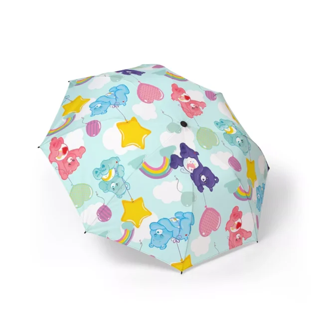 Little girl holding a clear Care Bears bubble umbrella in the rain.
