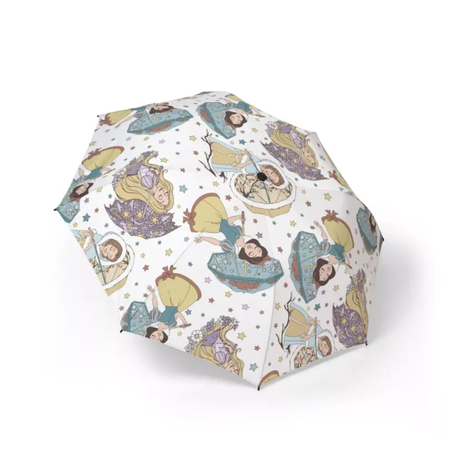 Side profile of a toddler safely shielded from the rain by a Disney Princess bubble umbrella.