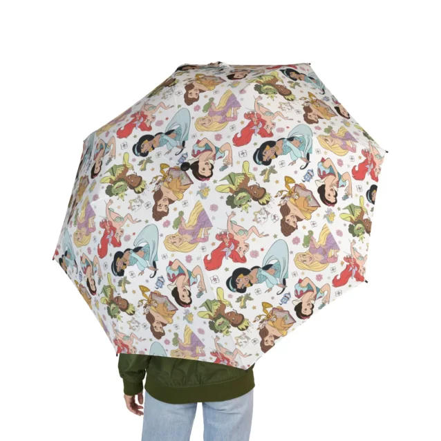 Little girl holding a clear Disney Princess bubble umbrella during a rainstorm.