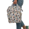The Boss Baby diaper bag carried on the go, showing the front pocket artwork.