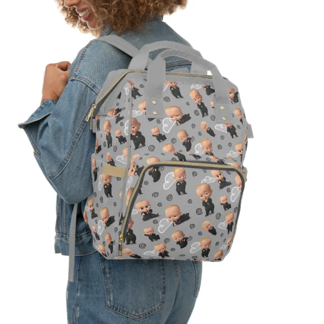 Mom wearing the grey Boss Baby diaper bag as a backpack for hands-free carrying.