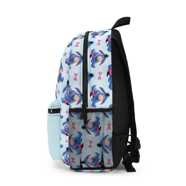 Blue Eeyore backpack from the side, showing the printed pattern wrapping around to the bottle pocket.