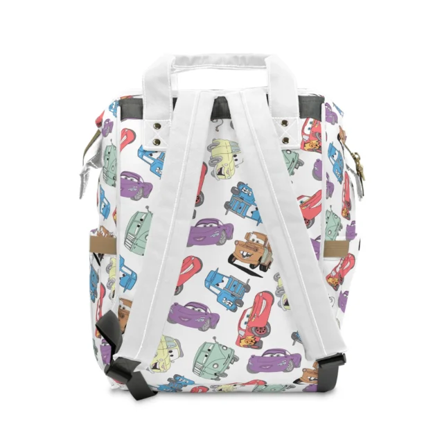Back view of the white pastel Cars toss diaper bag showing the padded back panel and straps.