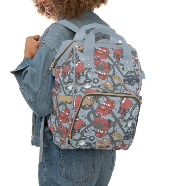 Grey Lightning McQueen diaper bag worn as a backpack for hands-free carrying.
