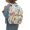Mom wearing the white Lion King diaper bag as a backpack for hands-free carrying.
