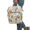 The Simba watercolor diaper bag carried on the go, showing the front pocket artwork.