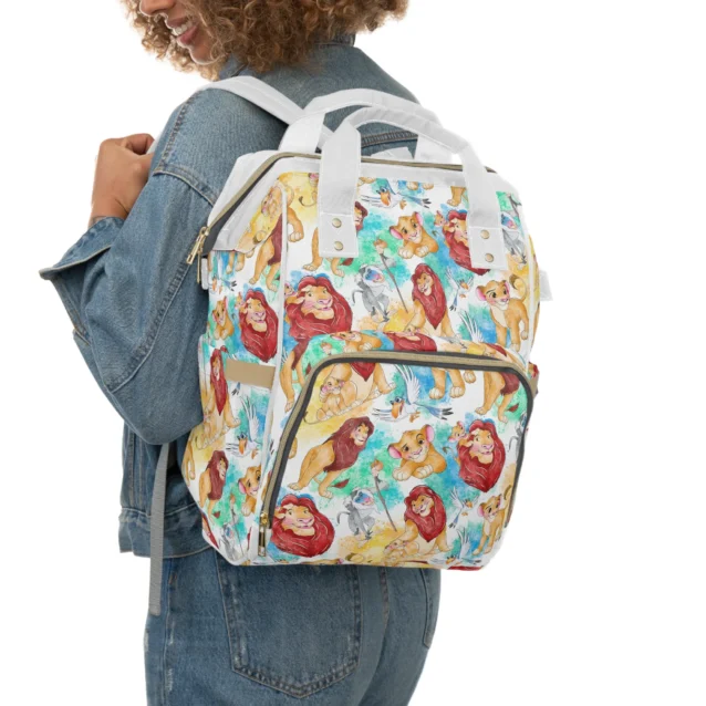 Mom wearing the white Lion King diaper bag as a backpack for hands-free carrying.