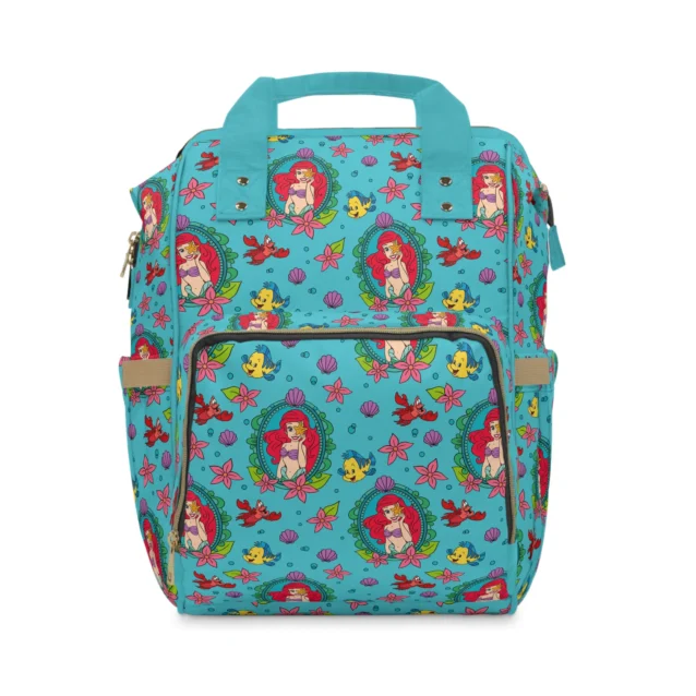 Teal Little Mermaid diaper bag backpack with chibi Ariel in flower wreaths, Flounder and Sebastian, the baby's name printed on the pocket.