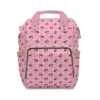 Pink Minnie Mouse diaper bag backpack with Minnie faces and white polka dots, the baby's name printed on the pocket.