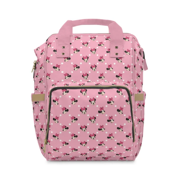 Pink Minnie Mouse diaper bag backpack with Minnie faces and white polka dots, the baby's name printed on the pocket.