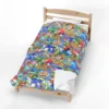 Sonic Blanket in the Sonic Character Collage design with Sonic, Tails, Knuckles and Amy, shown made up in a bedroom